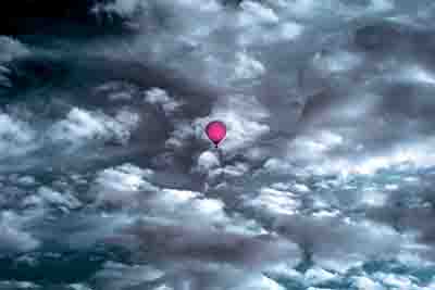 Hot air balloon in front of a dramatic sky