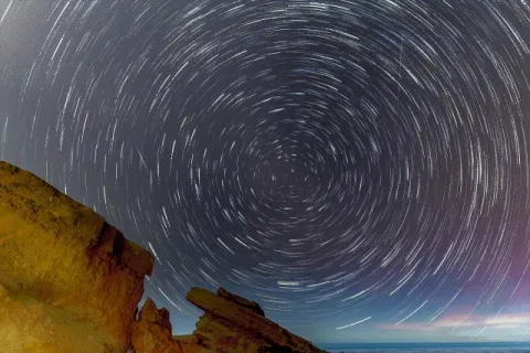 Startrails with rocks over the Atlantic