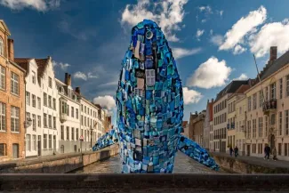 Whale made from rubbish in the canals of Bruges in Belgium