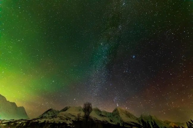 Northern lights in the Lyngenfjord Alps with Milky Way