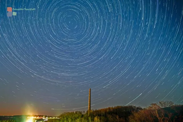 Startrails over an industrial chimney