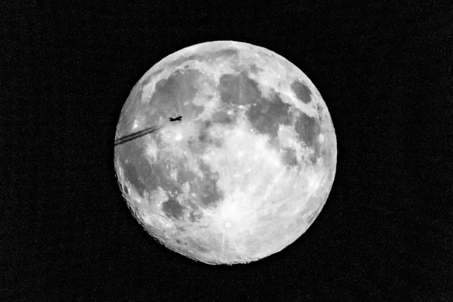 jet in front of super moon