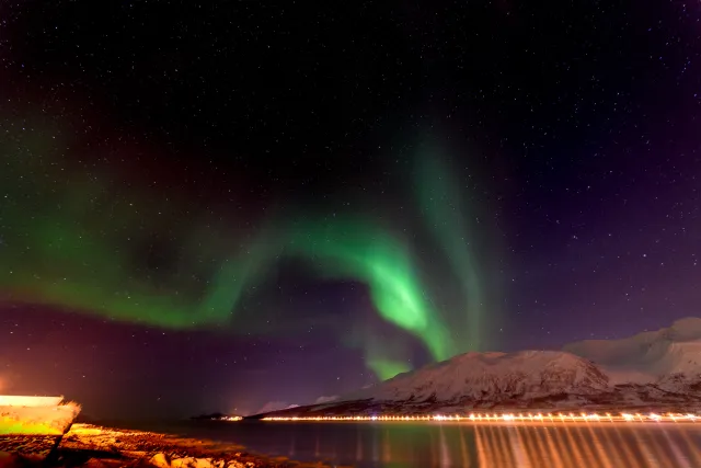 Northern lights over the Solenagen fjord in front of the Lyngenfjord Alps