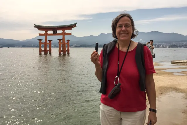 Karin with geocache in front of the Red Torii
