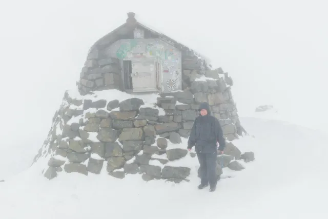 Arrive at the stone summit hut on Ben Nevis